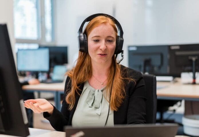 Red haired female student with headset